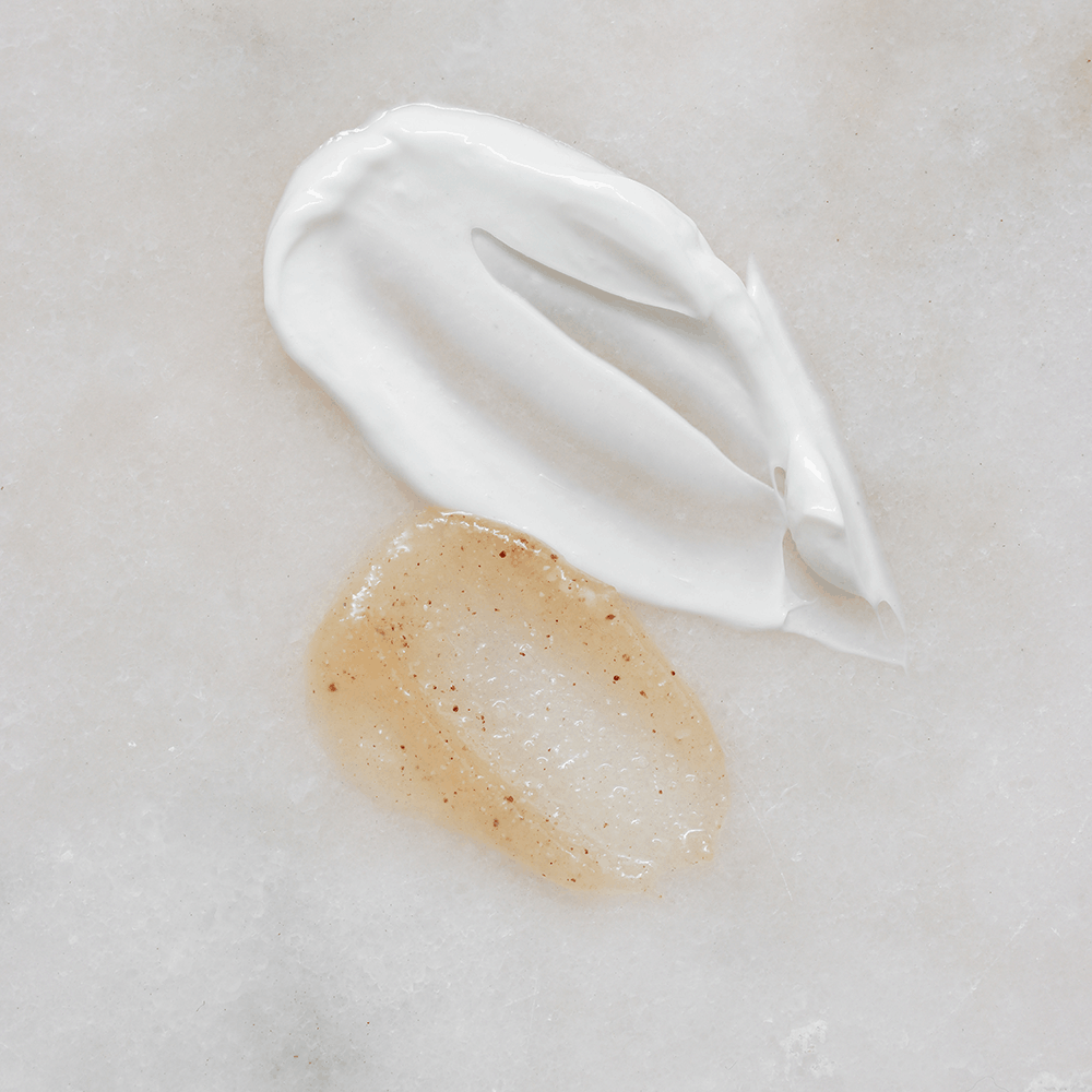 Two swatches of cream on a light gray background, one white and one beige.
